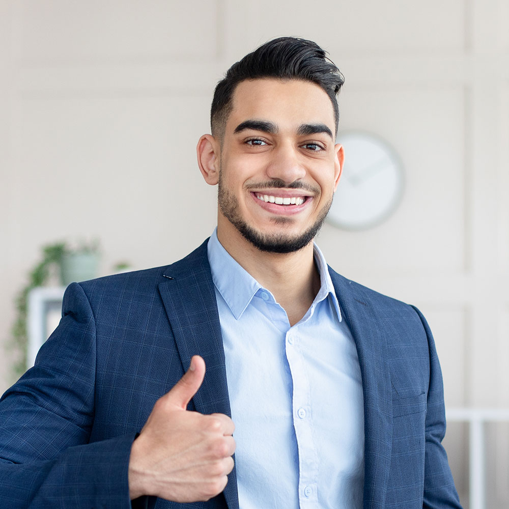 smiling-arab-businessman-holding-computer-showing-PAUEEHC.jpg